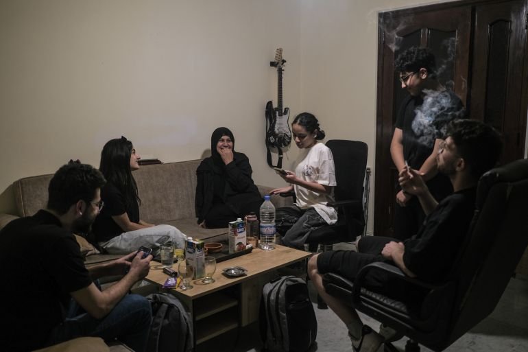 Iman Kandeel and some members of her family gather in their living room in Hadath, Beirut, a home they are contemplating leaving if the war between Israel and Lebanon escalates again [João Sousa/media]