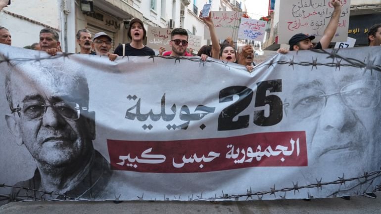 Demonstrators display a banner as protesters rally against Tunisian President Kais Saied on the fourth anniversary of his power grab, in Tunis, Tunisia, July 25, 2025. Demonstrators denounced Saied’s rule as authoritarian, calling the country an "open-air prison" and demanding the release of jailed opposition figures, journalists, and activists. REUTERS/Jihed Abidellaoui
