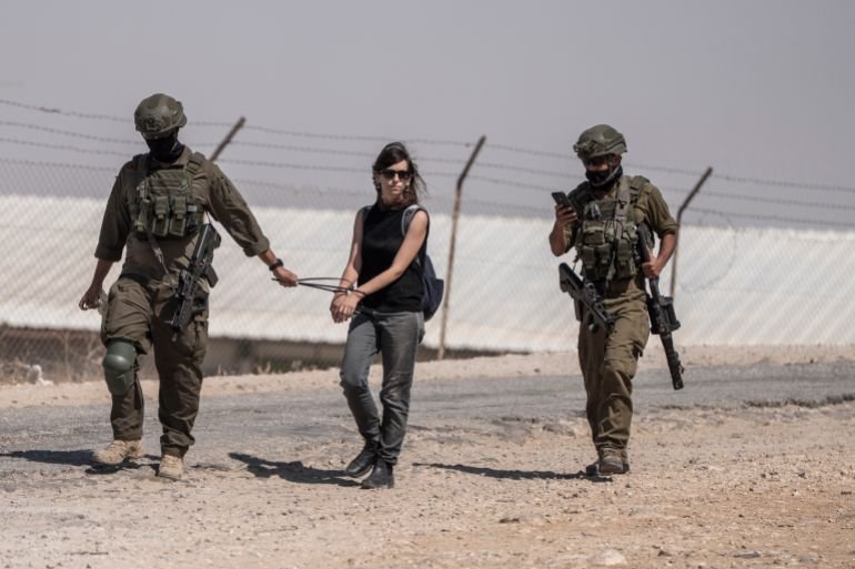 29 July 2025, Palestinian Territories, Hebron: Israeli Defense Forces arrest an activist as they raid the mourning tent where Palestinians of Umm Al-Khair community gatheted to mourn Awdah Al-Hathaleen, who was shot by an Israeli right-wing settler the previous day. Photo: Ilia Yefimovich/dpa (Photo by Ilia Yefimovich/picture alliance via Getty Images)