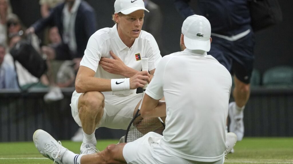 Jannik Sinner reaches the Wimbledon quarterfinals despite a bad elbow when an injured Dimitrov stops