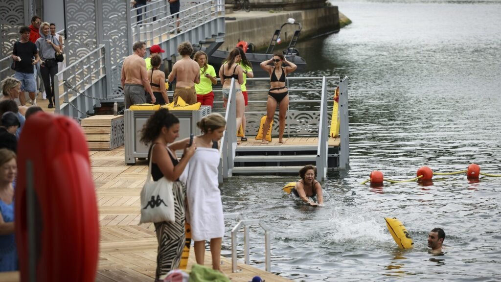 Joyful Parisians take a historic plunge into the Seine after 100 years