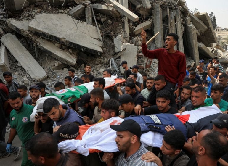 A flak jacket and a Palestinian flag are placed on the body of media journalist Anas Al Sharif, during the funeral for him, Mohammed Qreiqeh, Ibrahim Zaher, Mohammed Noufal and another colleague, who were killed in an Israeli strike, in Gaza City August 11, 2025. [Dawoud Abu Alkas/Reuters]