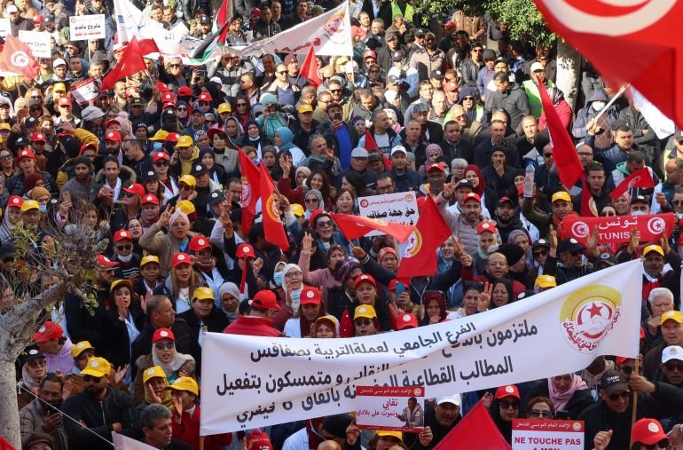 Supporters of the Tunisian General Labour Union (UGTT), carry banners and flags during a protest against President Kais Saied's policies, accusing him of trying to stifle basic freedoms including union rights, in Sfax, Tunisia February 18