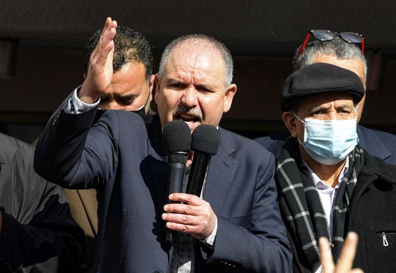 Secretary-General of the Tunisian General Labour Union (UGTT) Noureddine Taboubi delivers a speech as mployees of the Tunisian national airline Tunisair gather in front of the company's headquarters in the capital Tunis, on February 19, 2021, to protest against the seizure by a Turkish airline company of the accounts of Tunisair for the non-payment of its debts. (Photo by FETHI BELAID / AFP)