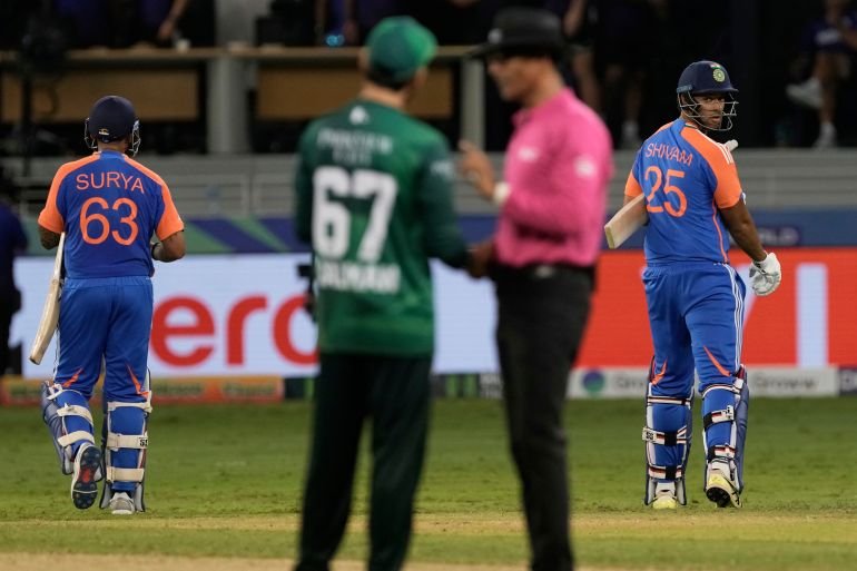 India's captain Suryakumar Yadav, left, and batting partner Shivam Dube, right, leave the field after their win in the Asia Cup cricket match against Pakistan at Dubai International Cricket Stadium in Dubai, United Arab Emirates, Sunday, Sept. 14, 2025. (AP Photo/Fatima Shbair)