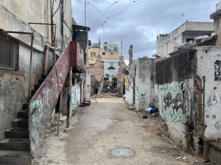 A narrow street surrounded by dilapidated houses