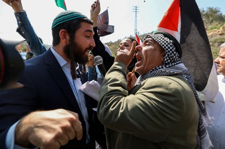 Knesset (Parliament) member for Israel's Religious Zionism party Tzvi Sukkot (L) is confronted as he tries to interrupt a rally by Palestinian and Israeli peace activists protesting at the entrance of Huwara in the occupied West Bank, on March 3, 2023, following deadly violence by Israeli settlers. (Photo by JAAFAR ASHTIYEH / AFP)