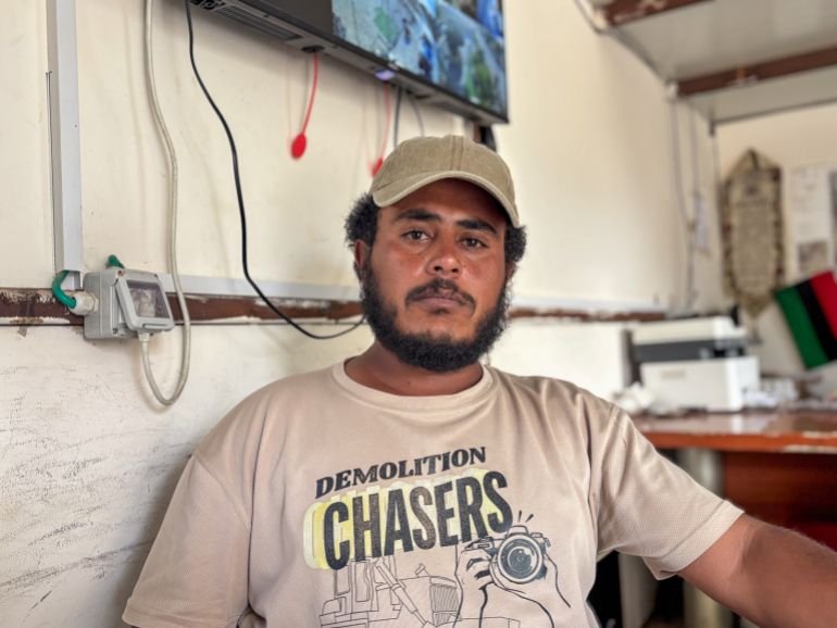 Tariq al-Hathaleen, wearing a beige cap and t-shirt, looks tearfully at the camera, still mourning the murder of Awdah
