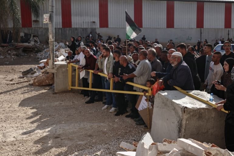 Residents of the Nur Shams refugee camp, near Tulkarem in the Israeli-occupied West Bank, gather at the entrance of the camp during a protest demanding the right to return to their homes, on November 18, 2025.