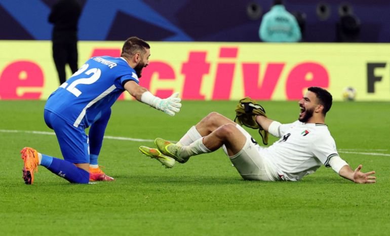 Soccer Football - FIFA Arab Cup - Qatar 2025 - Group A - Syria v Palestine - Education City Stadium, Al Rayyan, Qatar - December 7, 2025 Palestine's Ikram Rami Hamadeh and Hamed Hamdan celebrate after qualifying for the knockout stage REUTERS/Mohammed Salem TPX IMAGES OF THE DAY