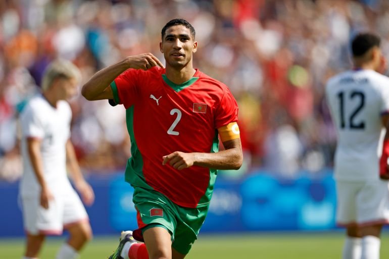 Morocco's Achraf Hakimi celebrates scoring his side's third goal during the quarterfinal men's soccer match between Morocco and the United States at the Parc des Princes during the 2024 Summer Olympics, Friday, Aug. 2, 2024, in Paris, France. (AP Photo/Aurelien Morissard)