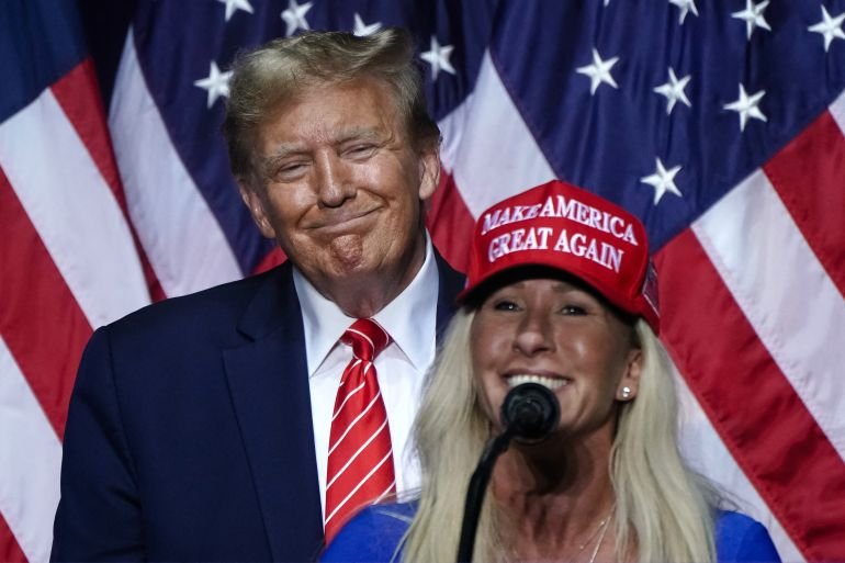(FILES) US Representative Marjorie Taylor Greene (R), Republican of Georgia, speaks alongside former US President and 2024 presidential hopeful Donald Trump at a campaign event in Rome, Georgia, on March 9, 2024.
