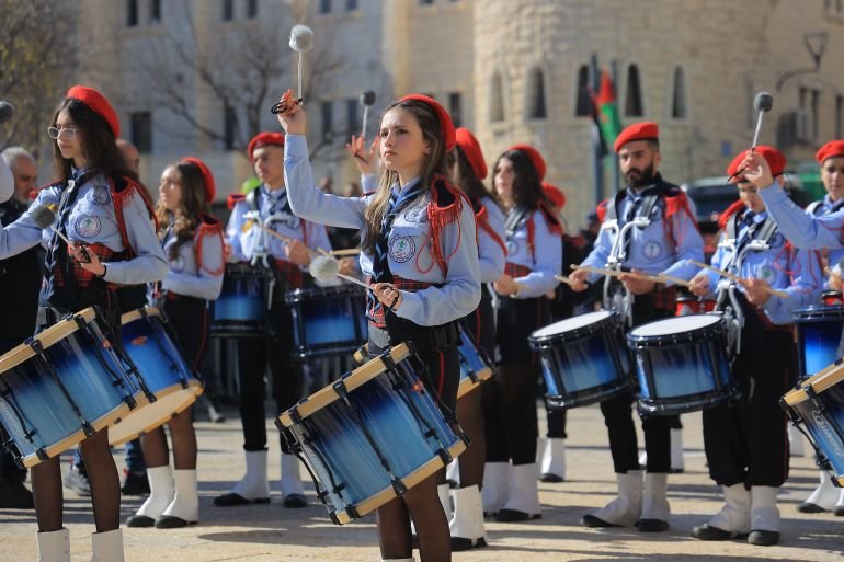 Palestinian young women play drums
