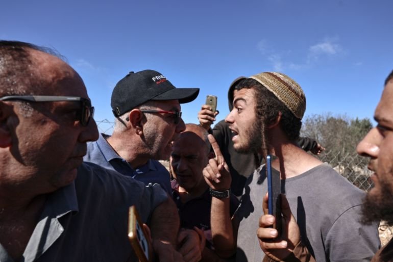 Palestinian farmers (L) scuffle with Israeli settlers during the olive harvest in the Palestinian village of Silwad, near Ramallah in the Israeli-occupied West Bank, on October 29, 2025.