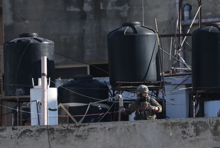 epa12564005 An Israeli soldier prepares explosive devices to demolish the house of Palestinian prisoner Abdul Karim Sanoubar in the West Bank city of Nablus, 02 December 2025. According to the Palestinian news agency Wafa, Israeli forces demolished the apartment of imprisoned Palestinian Abdul Karim Sanoubar in the West Bank village of Zawata, west of Nablus, following a raid at dawn. Sanoubar was detained by Israeli forces on 20 February 2025. EPA/ALAA BADARNEH