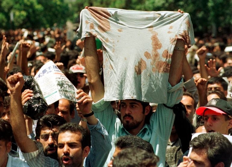 FILE - In this July 12, 1999 file photo, an unidentified student at a rally in Tehran, Iran, holds up the bloody T-shirt of a friend who was injured sometime in the last few days during clashes between police and student demonstrators. (AP Photo/Kamran Jebreili, File)