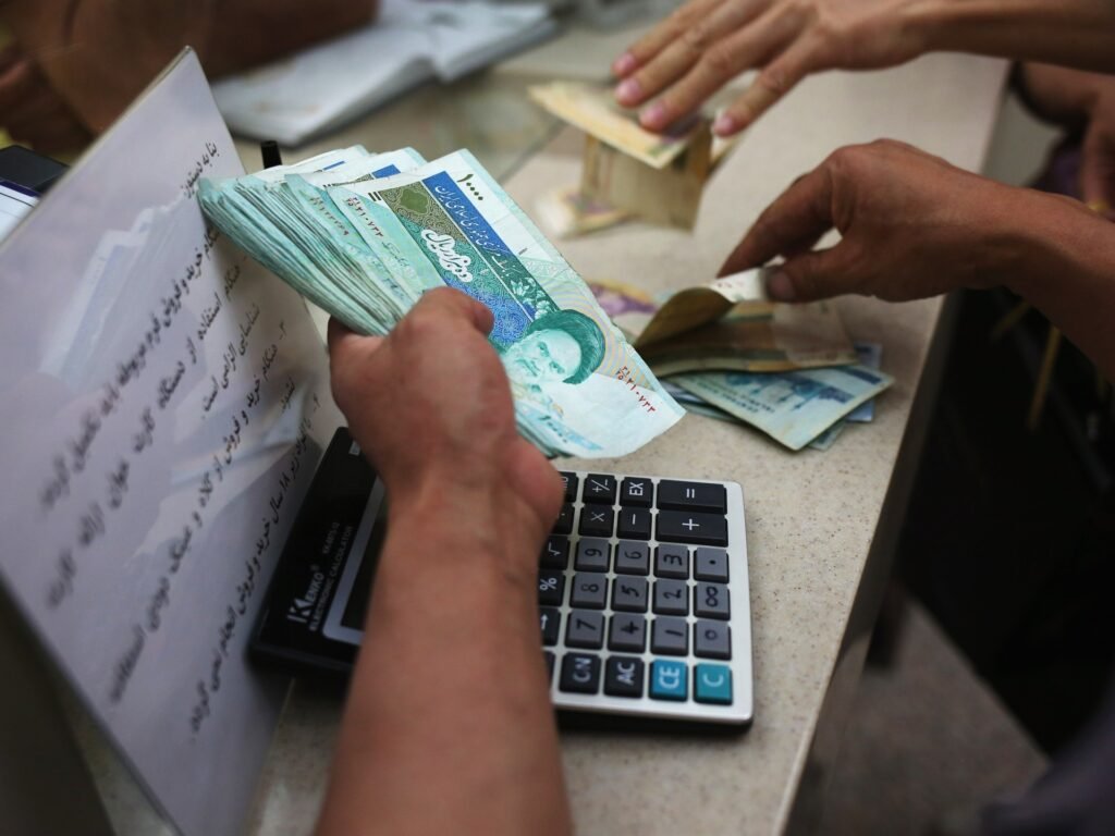 Iran’s currency drops to record low against dollar as tensions soar