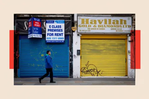 EPA - EFE/REX/Shutterstock A person walks on a street past closed-up shop fronts