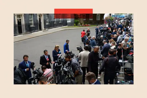 Bloomberg via Getty Images Members of the media report from outside 10 Downing Street in London, UK

