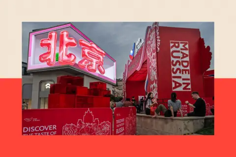 Getty Images The Chinese characters for Beijing are seen on a large screen at an event promoting Made In Russia goods and relations with China, at a shopping mall  in Beijing, China

