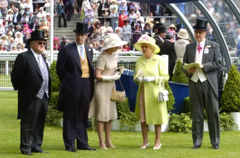David Hartley/Shutterstock David Rowland stands next to the former Prince Andrew as Queen Elizabeth II speaks to an unidentified woman before the start of the Gold Cup race at Ascot 2006
