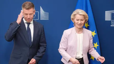 Getty Images Hungarian Prime Minister Peter Magyar (L) reacts as he is welcomed by the President of the European Commission Ursula von der Leyen (R) prior a bilateral meeting in the Berlaymont building