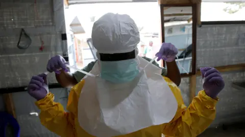 Reuters A health worker puts on Ebola protection gear before entering the Biosecure Emergency Care Unit (CUBE) at an Ebola treatment centre in Beni, in the Democratic Republic of Congo. 