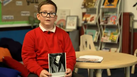BBC A boy with a photo