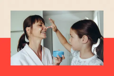 Getty Images Daughter putting facial cream on mother’s face 
