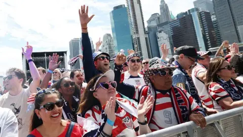 Getty Images A group of US fans cheer on the streets of New York City