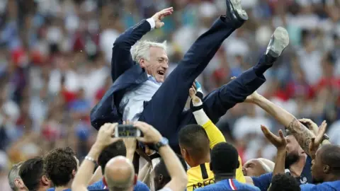 Getty Images Didier Deschamps is lifted up in the air by France players after their win in 2018 in Moscow