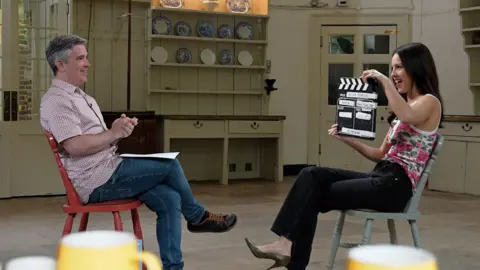 Olivia Rodrigo holds up a clapper board to signal the start of her interview with BBC News.