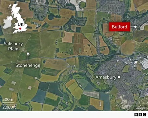Map showing the UK outline in the top left corner in white. The main larger image is a satellite picture of Salisbury Plain with Stonehenge and Bulford marked on the map. Bulford is highlighted in red with white writing.