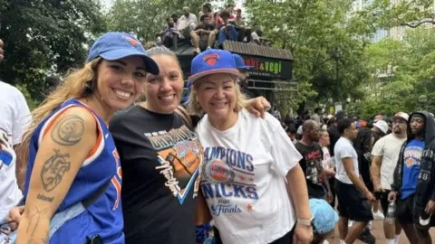 Grace Eliza Goodwin/BBC three women wearing knicks gear smilin ginto camera