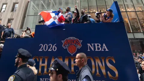 John Jones-Imagn Images New York Knicks championship bus shot from ground with police and crowds everywhere
