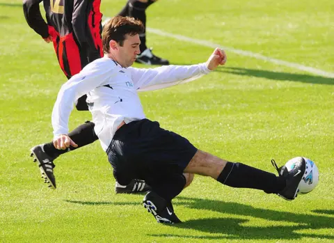 Getty Images Andy Burnham shoots at goal during the annual Labour MPs vs lobby journalists football match in Brighton in 2009.