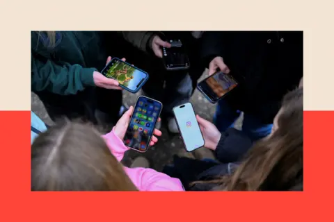 Reuters Teenagers standing in a circular formation while looking down at their mobile phones, in Bonn, Germany. Their faces are concealed. In the foreground is a girl with brown hair and wearing a pink top. The others wear darker clothing.