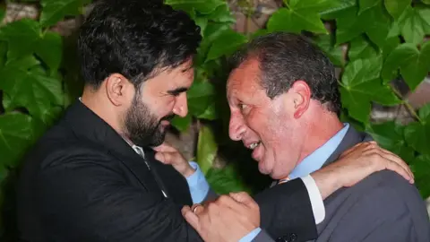 Bloomberg via Getty Images Mamdani and Lander embrace. 