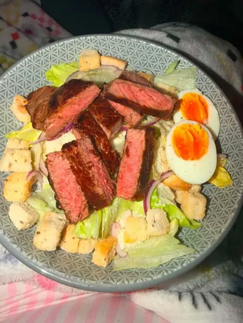Aimie Ludgate A plate with sliced cook steak, boiled eggs, crutons and lettuce