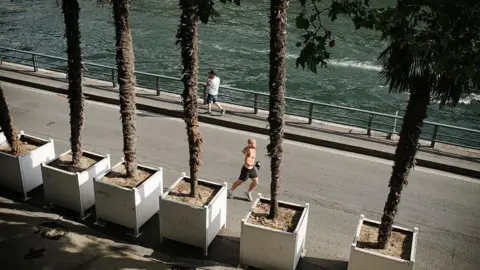 Getty Images A man runs along the Seine river