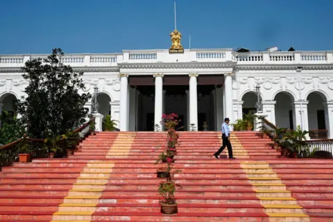 AFP via Getty Images A man walks along the stairs of of the National Library of India in Kolkata 