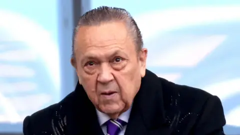 Getty Images David Sullivan, a man with swept-back grey hair wearing a dark coat and a navy tie, pictured at the London Stadium, West Ham's home ground.