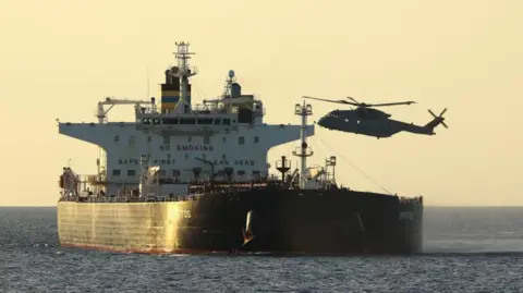 Ministry of Defence A helicopter boarding a vessel in the English Channel