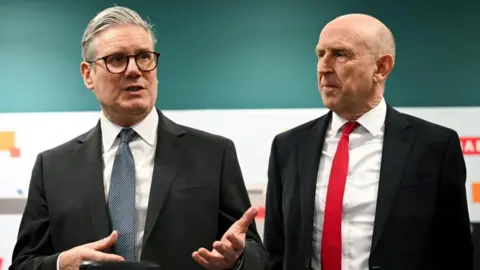 Reuters Sir Keir Starmer, left, stands next to John Healey