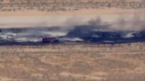 CBS A charred runway, with a fire truck seen responding