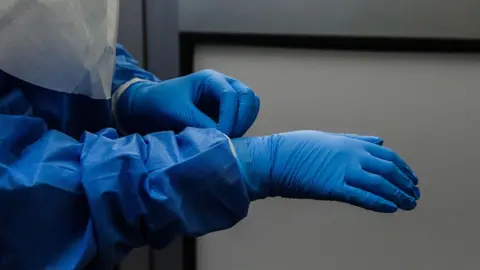 Getty Images A person wearing blue protective gear