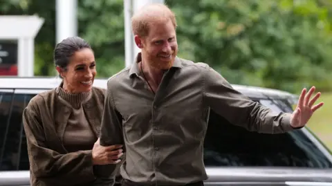 Reuters The Duke and Duchess of Sussex wave at the crowd after arriving at an event in Melbourne, Australia on 14 April 2026.