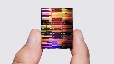 IBM Researcher holding IBM's sub-1 nm node chip
