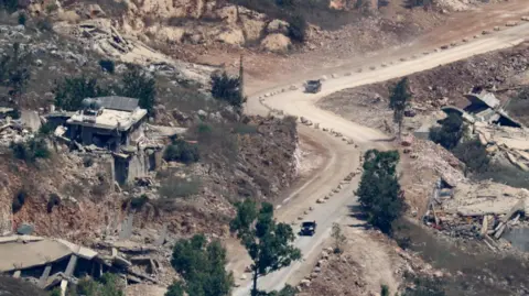 Reuters Israeli tanks operate on a road in southern Lebanon, pictured on June 27, 2026.