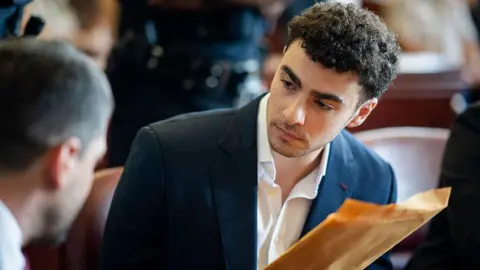 Getty Images Luigi Mangione appears at a hearing at Manhattan Criminal Court on June 17, 2026 in New York City. 

